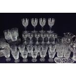 A set of six drinking glasses engraved with trees, on faceted stems, together with a collection of