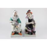 A pair of Staffordshire pottery figures of a cobbler and his wife, 32cm high (a/f)
