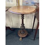 A Victorian walnut circular occasional table on baluster support with circular base and three paw