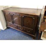A George III oak mule chest rising top with panelled front, canted corners and two low drawers, on