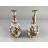 A pair of Doulton Lambeth Carrara ware vases, of bulbous form with fluted necks, with floral