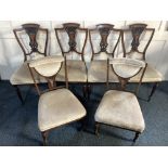 A set of four Edwardian inlaid rosewood salon chairs, with pierced vase splats on turned legs,