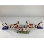 A pair of Staffordshire pottery recumbent figures of spaniels on rectangular bases 14.5cm, a pair of