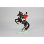 A Beswick model of a Huntsman on rearing horse no.868, second version, in brown gloss, 25.4cm