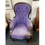 A Victorian spoonback armchair with purple button upholstery on turned legs and castors (a/f)