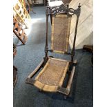 A Victorian small folding chair with carved and cane panel back and seat
