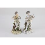 A near pair of Rudolstadt Volkstedt porcelain figures of musicians playing a guitar and a flute,