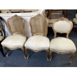 A pair of French Rococo style chairs, the carved and gilded frames with cane back, on cabriole legs,