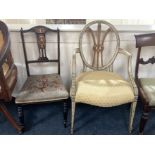 A Sheraton style painted elbow chair, the oval back with pierced Prince of Wales feather, cream