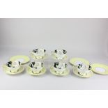 A Paragon porcelain part tea set decorated with yellow flowers on black ground, comprising six tea