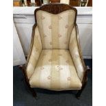 An Edwardian inlaid armchair with urn panelled top rail, swept arms on square tapered legs and