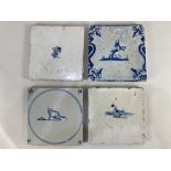 Four Dutch Delft wall tiles, decorated with a cat, a deer, a bird and a flowerhead (a/f)