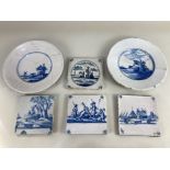Four Dutch Delft wall tiles, two decorated with Biblical scenes, and two with buildings, together