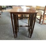 An early 20th century nest of three inlaid mahogany tables, largest 48.5cm by 33cm