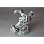 A continental porcelain model of a nude figure riding a chariot, blue Samson style mark to base,