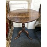 A George III oak circular occasional table with tilting top on baluster stem and tripod base, 63cm