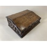 A Victorian carved oak slope front writing box, with contents, the back and sides decorated with