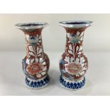 A pair of Chinese porcelain vases, relief decorated with flowers, in rust, blue and green, character