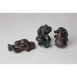 Two Japanese wood netsuke of toads, to include one standing on a snail, 5.5cm high, both with