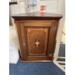 An early 19th century mahogany corner cabinet with satinwood cross banding and inlaid urn to door