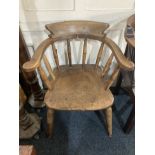 A smokers bow captains elbow chair, the raised back with turned supports, and solid seat on turned