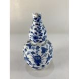 A Chinese blue and white porcelain gourd shaped vase, decorated with birds amongst plants, character