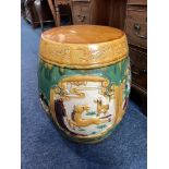 A Chinese ceramic barrel shaped garden seat, decorated with panels of landscapes and animals, in