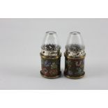 A pair of Chinese opium lamps, the metal bases enamelled with floral decoration, 11cm high