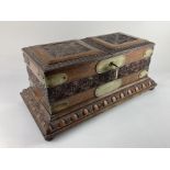 A Victorian metal bound carved oak smokers box, the two flaps opening to reveal an arrangement of