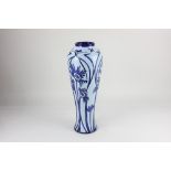 A Moorcroft pottery 'Ragged Poppy' blue on blue vase, designed by Nicola Slaney, with tube lined