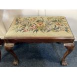 A mahogany rectangular stool with tapestry upholstered drop in seat on cabriole legs with carved