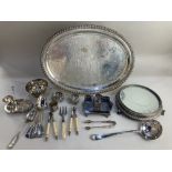 A silver plated oval serving tray 50cm a circular mirror topped table stand on cast sphinx feet,