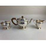 A George V silver three piece tea set, maker William Comyns & Sons Ltd, London 1934, with engraved