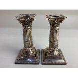 A pair of Victorian silver dwarf Corinthian column candlesticks, maker Martin, Hall & Co, London