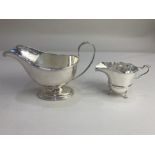 An Elizabeth II silver sauce boat, maker Mappin & Webb, Sheffield 1968, together with a silver cream