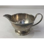 An Elizabeth II silver cream jug, maker Cooper Brothers & Sons Ltd, Sheffield 1963, of plain
