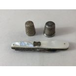 A Victorian mother of pearl and silver pen knife, Birmingham 1890, and two silver thimbles