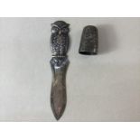 A novelty silver owl page marker, stamped 830 8.5cm and a Victorian silver thimble (a/f), Birmingham