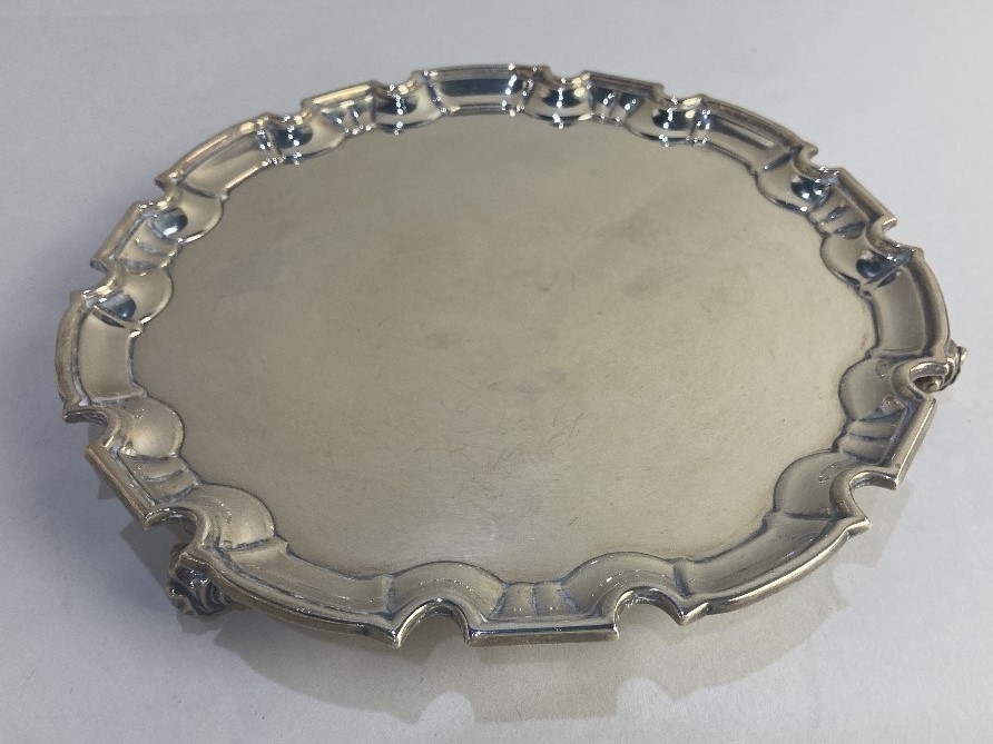 A George V silver salver, maker William Hutton & Sons, Sheffield 1924, with piecrust border, on