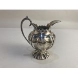 An Edward VII silver milk jug, maker Elkington & Co, Sheffield 1906, of squash form with scalloped