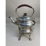 A George V silver kettle on stand, oval form with base and spirit burner on scroll legs and paw