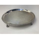 A George III oval silver teapot stand, maker Hester Bateman, London 1786, with beaded border on claw
