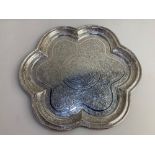 An Indian white metal tray, the engraved design depicting birds amongst foliage, of scalloped