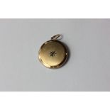 A 15ct gold cased small round locket set with a rose cut diamond