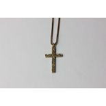 A 9ct gold crucifix and chain with engraved decoration