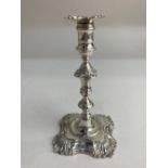 A George II silver taper stick, maker John Cafe, London 1752, crested and monogrammed, sconce