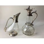 Two silver plate mounted cut glass claret jugs, one of globular form with narrow neck, with etched