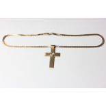 A diamond set cross pendant on a gilt neck chain