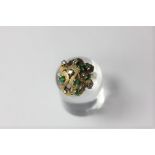 An emerald and diamond foliate cluster ring in gold (marks worn)
