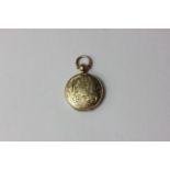 A gold scroll engraved locket